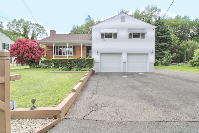 47 Delmont Rd, East Hartford, CT 06108 - tri-level home featuring a chimney, a front lawn, driveway, an attached garage, and brick siding