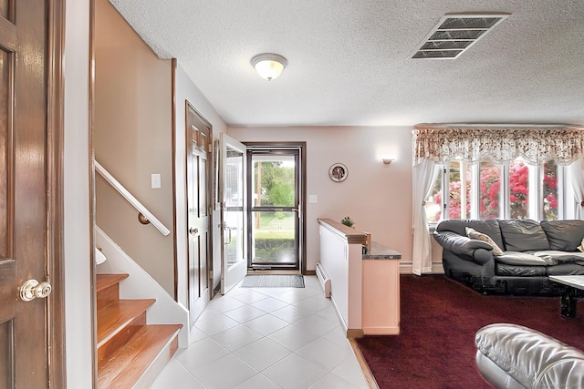 47 Delmont Rd, East Hartford, CT 06108 - tiled entryway featuring a textured ceiling, stairway, and a baseboard heating unit