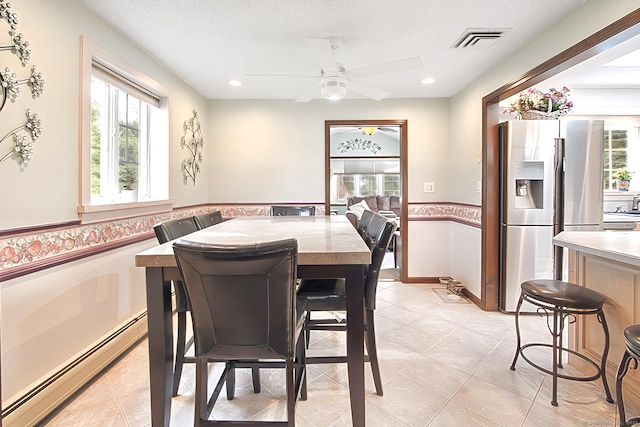47 Delmont Rd, East Hartford, CT 06108 - dining area with baseboard heating, ceiling fan, recessed lighting, light tile patterned floors, and a wainscoted wall