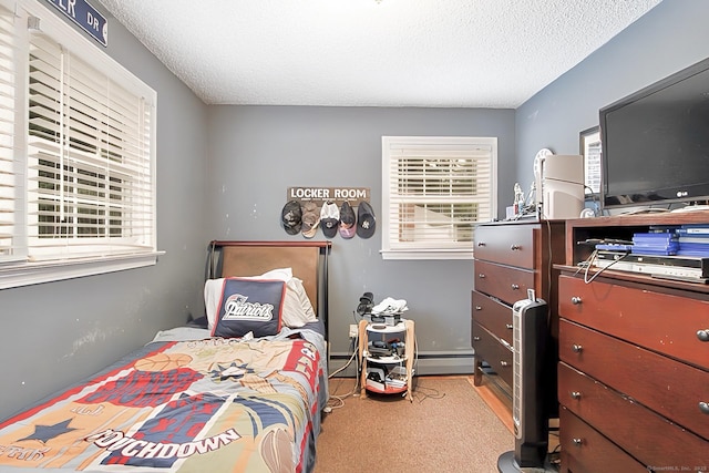 47 Delmont Rd, East Hartford, CT 06108 - bedroom featuring a textured ceiling, a baseboard heating unit, and carpet