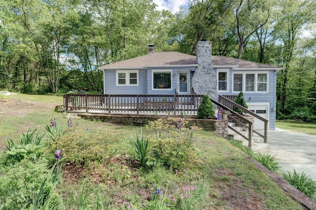 187 W Main St, East Lyme, CT 06357 - ranch-style house with a chimney, driveway, a wooden deck, a garage, and view of scattered trees