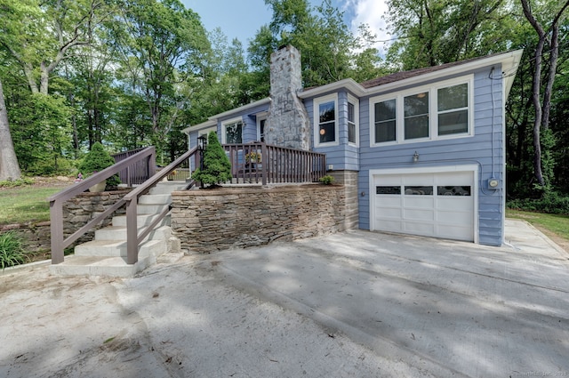 187 W Main St, East Lyme, CT 06357 - single story home with driveway, a chimney, stairs, and a garage