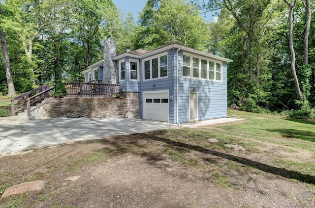 187 W Main St, East Lyme, CT 06357 - view of front of house with a chimney, driveway, an attached garage, and stairway