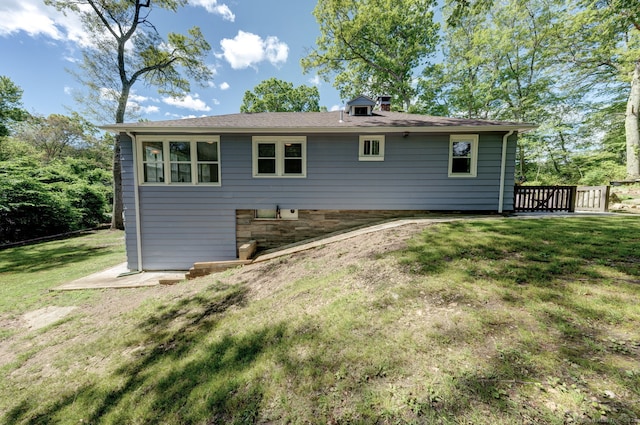 187 W Main St, East Lyme, CT 06357 - rear view of property featuring a lawn and a chimney