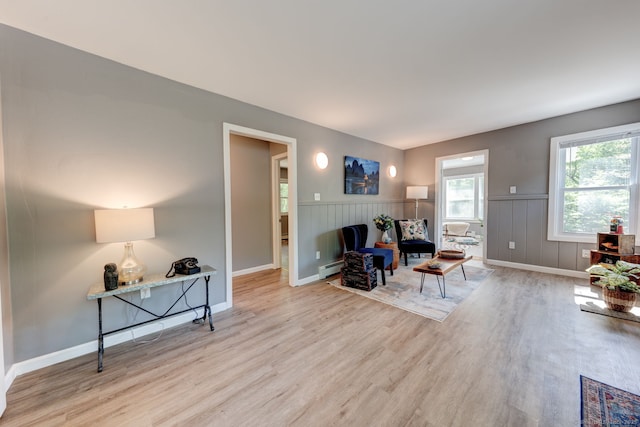 187 W Main St, East Lyme, CT 06357 - sitting room with wood finished floors, a wainscoted wall, a baseboard heating unit, and baseboards