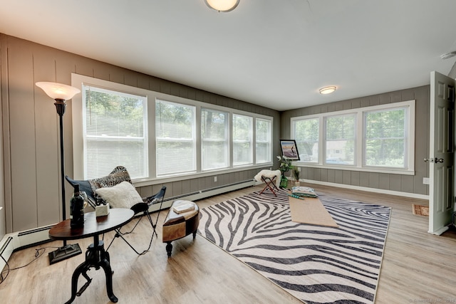 187 W Main St, East Lyme, CT 06357 - living room with wood finished floors, a baseboard heating unit, and a decorative wall