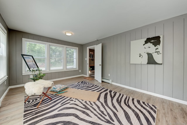 187 W Main St, East Lyme, CT 06357 - living area with a baseboard heating unit, wood finished floors, and baseboards
