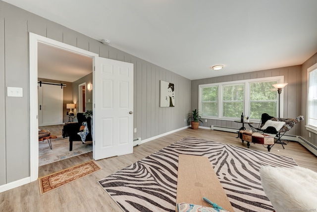 187 W Main St, East Lyme, CT 06357 - sitting room featuring a barn door, light wood-style flooring, baseboards, and a baseboard radiator