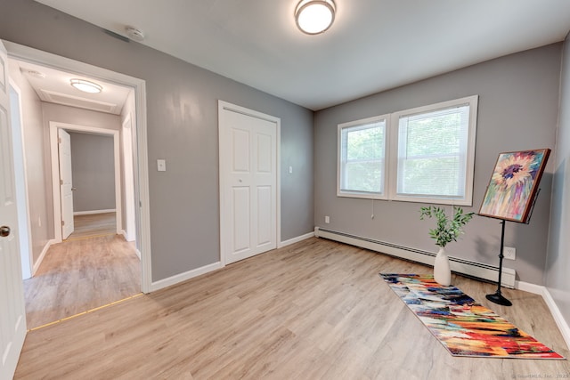 187 W Main St, East Lyme, CT 06357 - unfurnished bedroom featuring light wood-style floors, baseboards, and a baseboard heating unit