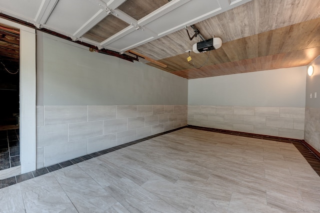 187 W Main St, East Lyme, CT 06357 - garage featuring a garage door opener and a wainscoted wall