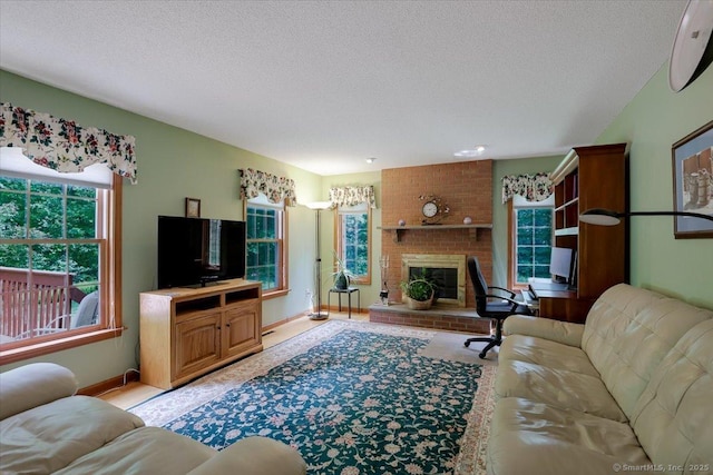 109 Edstrom Rd, Marlborough, CT 06447 - living room featuring a textured ceiling, baseboards, and a brick fireplace
