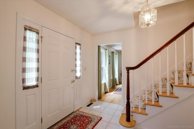 109 Edstrom Rd, Marlborough, CT 06447 - entrance foyer featuring light tile patterned floors, a chandelier, and stairs