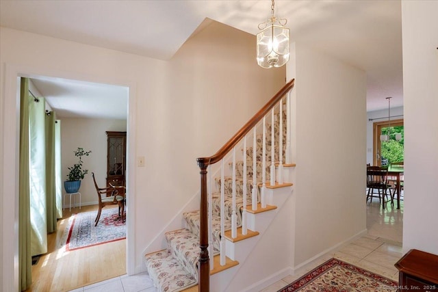 109 Edstrom Rd, Marlborough, CT 06447 - staircase with tile patterned flooring, a chandelier, and baseboards