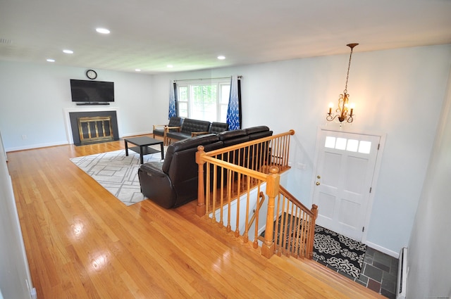 83 Elizabeth St, South Windsor, CT 06074 - living room with wood finished floors, recessed lighting, a chandelier, baseboards, and a fireplace with flush hearth