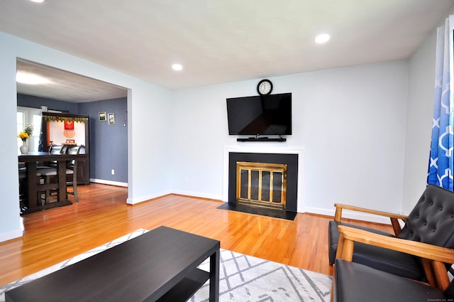 83 Elizabeth St, South Windsor, CT 06074 - living area with a fireplace with flush hearth, wood finished floors, baseboards, and recessed lighting
