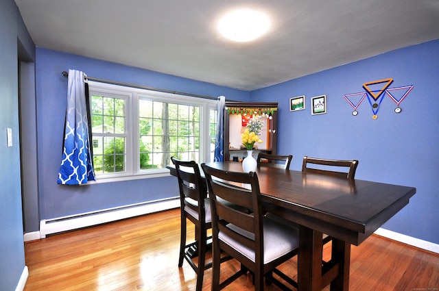 83 Elizabeth St, South Windsor, CT 06074 - dining room with a baseboard radiator, wood finished floors, and baseboards