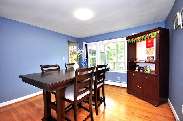 83 Elizabeth St, South Windsor, CT 06074 - dining area with a baseboard radiator, light wood-type flooring, and baseboards