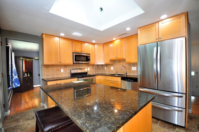 83 Elizabeth St, South Windsor, CT 06074 - kitchen with stainless steel appliances, a sink, light brown cabinets, decorative backsplash, and recessed lighting