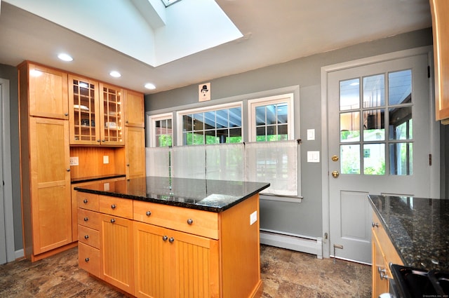 83 Elizabeth St, South Windsor, CT 06074 - kitchen with a baseboard radiator, stone finish flooring, a skylight, glass insert cabinets, and dark stone counters