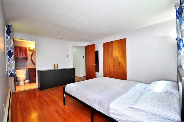 83 Elizabeth St, South Windsor, CT 06074 - bedroom with wood finished floors, a baseboard heating unit, and ensuite bath