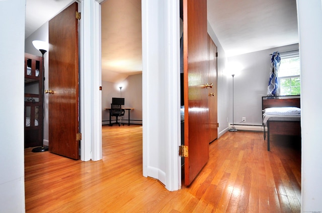 83 Elizabeth St, South Windsor, CT 06074 - hall featuring a baseboard heating unit, light wood-style floors, an office area, baseboards, and vaulted ceiling