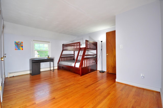 83 Elizabeth St, South Windsor, CT 06074 - bedroom with light wood finished floors, a baseboard radiator, baseboard heating, and baseboards