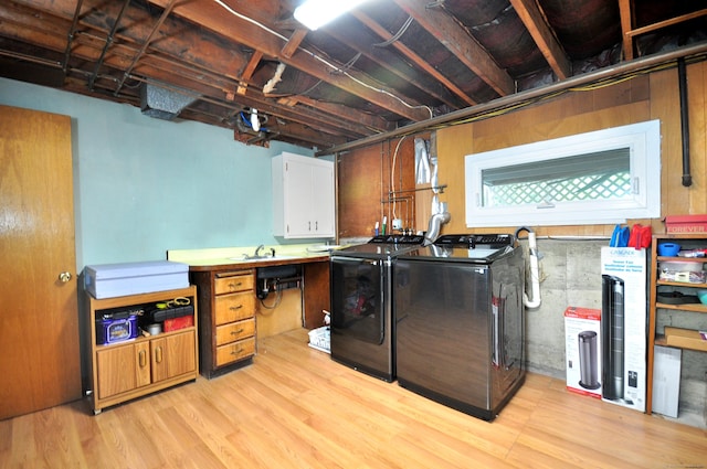 83 Elizabeth St, South Windsor, CT 06074 - laundry area with separate washer and dryer, light wood finished floors, and cabinet space