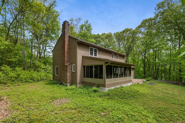 61 Winding Rdg, Southington, CT 06489 - back of property with a chimney, a sunroom, and a lawn