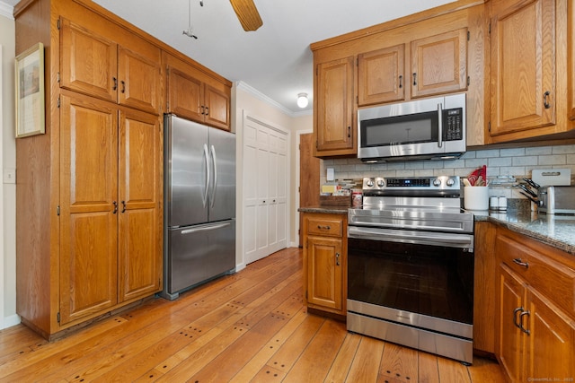 61 Winding Rdg, Southington, CT 06489 - kitchen featuring appliances with stainless steel finishes, ornamental molding, light wood-style floors, brown cabinets, and backsplash