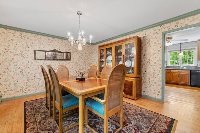 61 Winding Rdg, Southington, CT 06489 - dining area with light wood-type flooring, crown molding, wallpapered walls, a chandelier, and baseboards