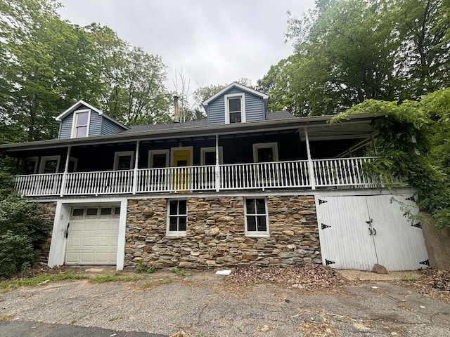 29 Middle Tpke, Mansfield, CT 06268 - view of front of property with stone siding, a balcony, an attached garage, and driveway