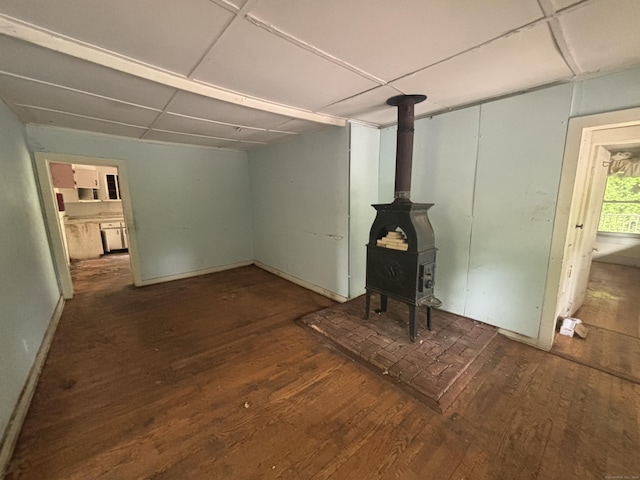 29 Middle Tpke, Mansfield, CT 06268 - unfurnished living room with a wood stove, wood finished floors, baseboards, and a paneled ceiling