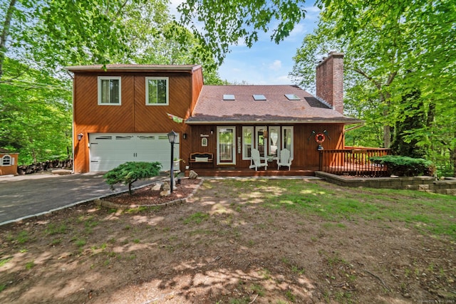 19 Sanford St, Wolcott, CT 06716 - view of front facade with asphalt driveway, an attached garage, and a chimney