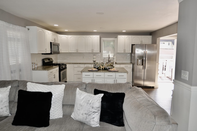 155 Cedar St, New Haven, CT 06519 - kitchen with stainless steel appliances, white cabinets, tasteful backsplash, and light stone counters