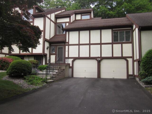 690 Forest Rd Unit 442, West Haven, CT 06516 - tudor home featuring stucco siding, a garage, driveway, and a shingled roof