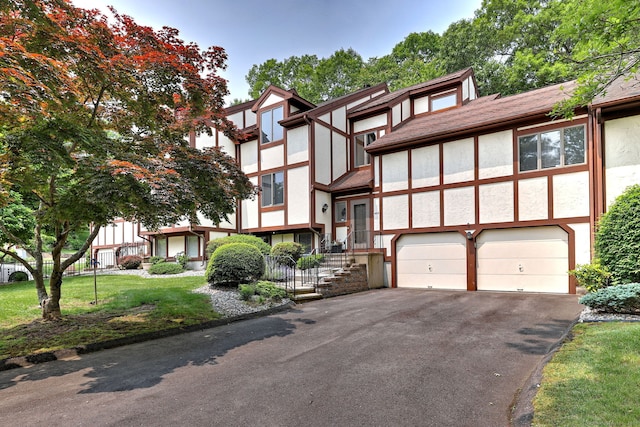 690 Forest Rd Unit 442, West Haven, CT 06516 - english style home with stucco siding, an attached garage, asphalt driveway, and a front lawn