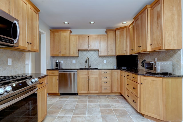 690 Forest Rd Unit 442, West Haven, CT 06516 - kitchen featuring appliances with stainless steel finishes, a sink, backsplash, dark stone countertops, and recessed lighting