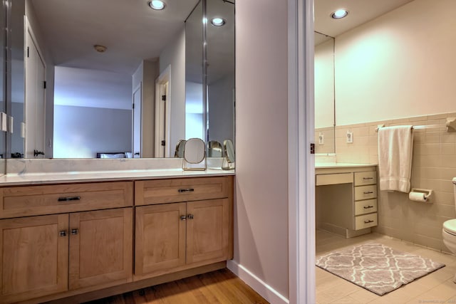 690 Forest Rd Unit 442, West Haven, CT 06516 - full bath with toilet, vanity, tile walls, wood finished floors, and a wainscoted wall