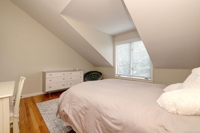 690 Forest Rd Unit 442, West Haven, CT 06516 - bedroom with wood finished floors, lofted ceiling, and baseboards