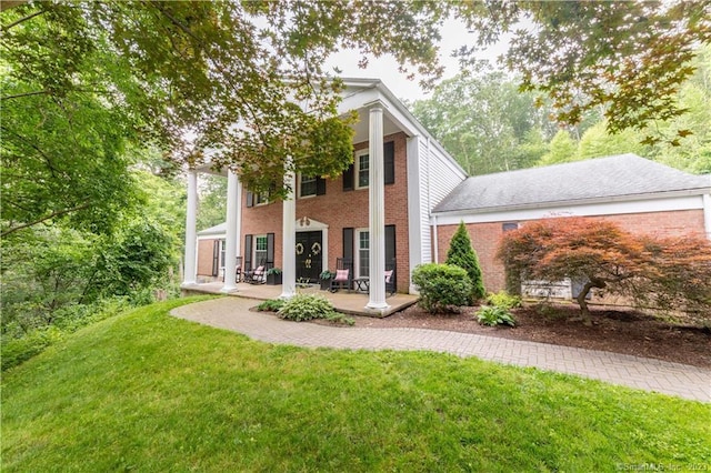 36 Old Johnson Ln, Middletown, CT 06457 - rear view of property with covered porch, a yard, and brick siding