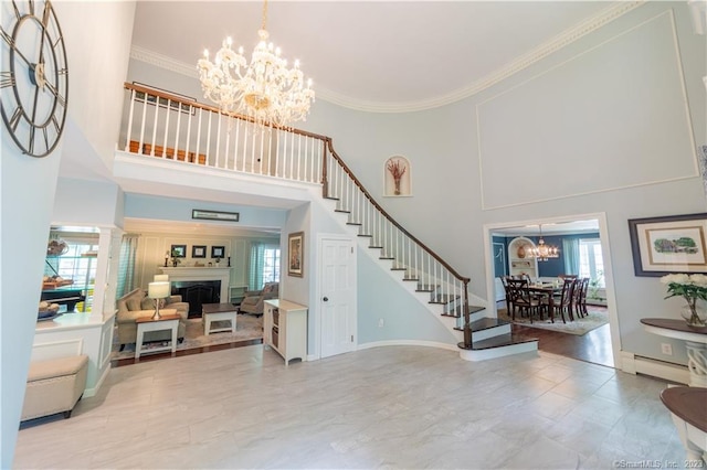 36 Old Johnson Ln, Middletown, CT 06457 - entryway with a chandelier, a towering ceiling, stairway, a baseboard heating unit, and ornamental molding
