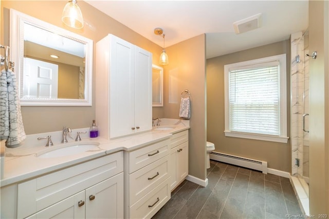 36 Old Johnson Ln, Middletown, CT 06457 - full bath with a baseboard heating unit, double vanity, a stall shower, toilet, and baseboards