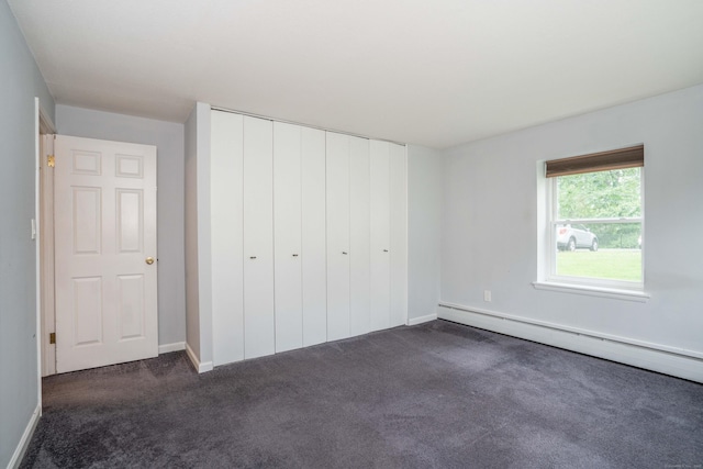 104 Oakwood Ave Apt T3, West Hartford, CT 06119 - unfurnished bedroom with a baseboard radiator, dark carpet, a closet, and baseboards