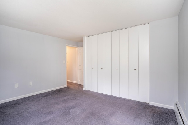 104 Oakwood Ave Apt T3, West Hartford, CT 06119 - unfurnished bedroom with baseboard heating, dark carpet, baseboards, and a closet
