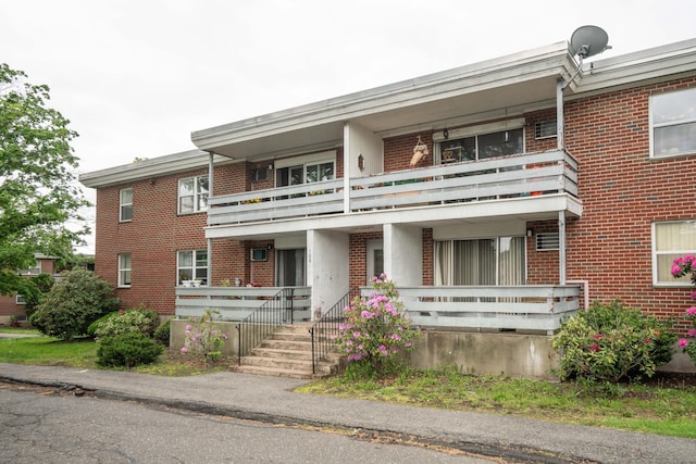104 Oakwood Ave Apt T3, West Hartford, CT 06119 - view of front facade featuring a balcony, brick siding, and a porch
