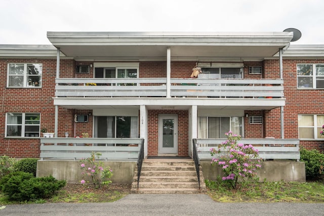 104 Oakwood Ave Apt T3, West Hartford, CT 06119 - view of front facade with a balcony, brick siding, and a porch