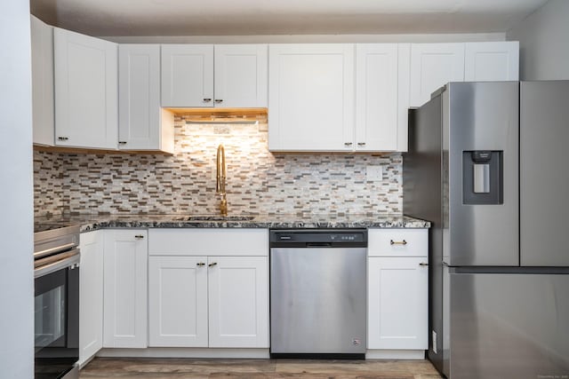 104 Oakwood Ave Apt T3, West Hartford, CT 06119 - kitchen featuring stainless steel appliances, a sink, dark stone countertops, and white cabinetry