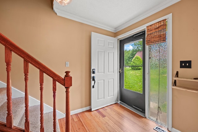 36 Wood Duck Ln Unit 36, Simsbury, CT 06081 - foyer entrance with crown molding, light wood-style flooring, stairs, a textured ceiling, and baseboards