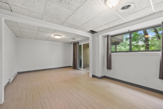 36 Wood Duck Ln Unit 36, Simsbury, CT 06081 - unfurnished room with a drop ceiling, baseboard heating, light wood-style flooring, and baseboards