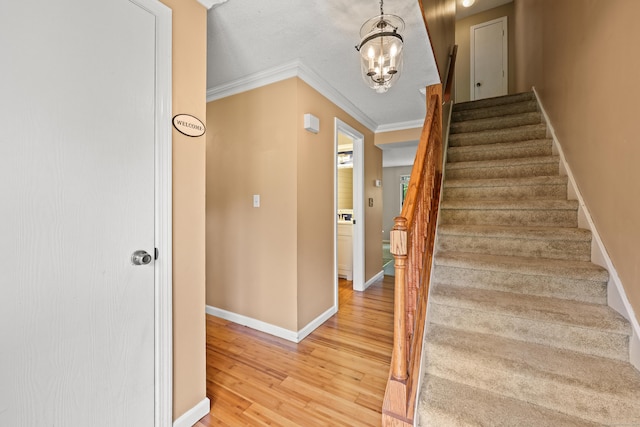36 Wood Duck Ln Unit 36, Simsbury, CT 06081 - staircase with wood finished floors, a chandelier, baseboards, and crown molding